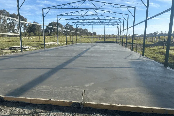 A new concrete shed slab under a steel shed frame